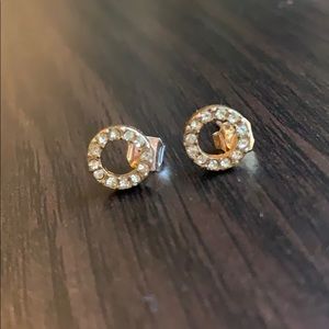 Pair of golden colored circle earrings.